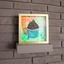 Load image into Gallery viewer, Framed artwork of a colorful cupcake on a brick wall.
