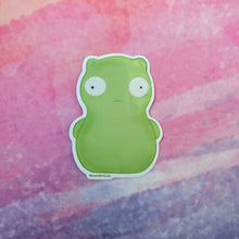 Load image into Gallery viewer, Green cartoon character sticker on a watercolor background
