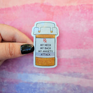 Sticker of a pill bottle labeled 'My neck my back my anxiety attack' held against a colorful background.