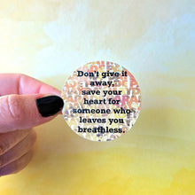 Load image into Gallery viewer, Round sticker with motivational quote held by a hand against a blurred background

