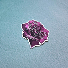 Load image into Gallery viewer, Purple sticker with text 'She left me roses by the stairs' on a textured light blue background
